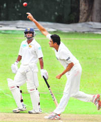 Anil Kumble (R) bowls as Chamara Silva looks on during the first day of a three-day practice match between India and Sri Lanka Board XI in Colombo on Friday. 