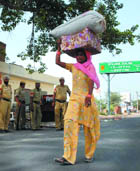 A woman crosses inter-state border to enter Haryana during the curfew.