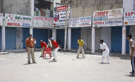 Youngsters playing cricket as markets remained partially closed.