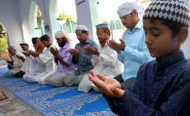 Members of the Muslim community (above) praying for peace in the aftermath of Dera-Sikh clash at the Haji Rattan mosque in Bathinda on Saturday