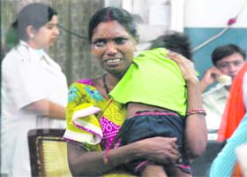 A grieving mother with her child at the hospital