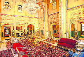 The Durbar Suite of the Raj Palace Hotel, Jaipur, has gold and silver furniture and gold-painted walls with overhanging jharokas
