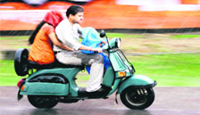 A family braves rain to reach their destination in Jammu on Sunday. 