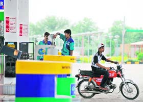 A Pakistani motorcycle rider leaves a petrol station in Jhelum
