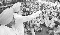 Members of Bhartiya Kisan Union hold a dharna in front of the main gate of PSEB headquarters in Patiala