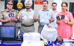 Investigating officials show the recovered passports in Chandigarh