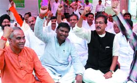 Jharkhands former Chief Minister Arjun Munda ( centre) along with NDA supporters shout slogans during a demonstration against the UPA Government at Jantar Mantar in New Delhi
