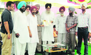 Jagdev Singh Jassowal, founder and patron of the Prof Mohan Singh Foundation, releases two books at Government Senior Secondary School, Dhanansu, on Monday. 