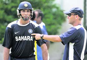 Indian coach Gary Kirsten (R) shares a batting tip with batsman V V S Laxman during a practice session ahead of first cricket test against Sri Lanka, Colombo, Sri Lanka