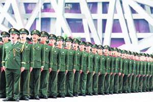 Chinese paramilitary policemen chant slogans near the National Stadium also called the Birds Nest at the Olympic Green in Beijing