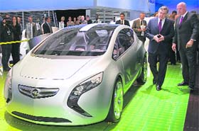 Britain's Prime Minister Gordon Brown (2nd R) and CEO of General Motors Europe, Carl-Peter Forster (R), look at the new hybrid Vauxhall 'Flextreme' concept car at the British International Motor Show in London
