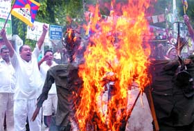 Tibetans activists burn effigy of the Chinese President during a demonstration for their demands at Jantar Mantar in New Delhi