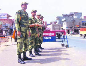 Jawans of the BSF stand guard near a barricade in Sirsa town on Tuesday.