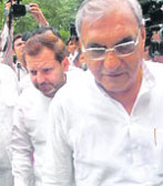 Haryana Chief Minister Bhupinder Singh Hooda with Karnal MP Arvind Sharma on way to Parliament on Tuesday.