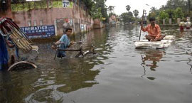 People find it tough to commute on a flooded road in Patna on Tuesday.