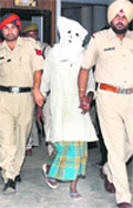 One of the accused (face covered) in the Rita Bawa murder case being produced in court in Jalandhar