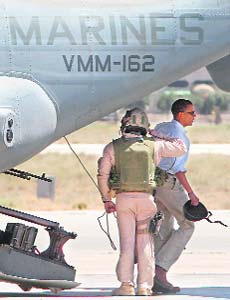 US Democratic presidential candidate Senator Barack Obama is saluted as he steps off an osprey upon arriving at Marka Airport in Amman