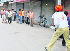 Youths play cricket in the deserted Chaura Bazar due to bandh in Ludhiana on Wednesday.  