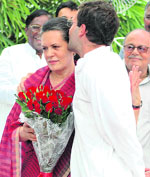 UPA chairperson Sonia Gandhi with her son and AICC general secretary Rahul Gandhi during a function to celebrate the UPA governments win in the confidence vote in Parliament, at Sonias residence in New Delhi