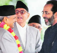 Nepals President Ram Baran Yadav (left) is congratulated by Indian Ambassador Rakesh Sood after the oath-taking ceremony at the presidential building in Kathmandu on Wednesday. Also in the picture is Prime Minister Girija Prasad Koirala. 