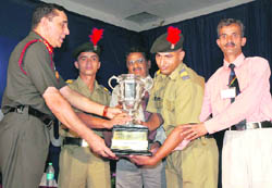 The Army chief, Gen Deepak Kapoor, honours an NCC cadet with a trophy at Sainik School, Kunjpura, on the founders day of the institution on Thursday.
