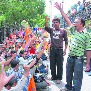 Demanding the reopening of the unit, employees of the Super Max, Shoghi, hold a protest in front of the deputy commissioners office in Shimla on Thursday.