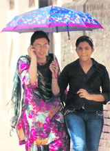 College students protect themselves from the scorching sun in Ludhiana