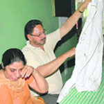 Raghbir Singh Grewal shows his bloodstained shirt while his wife breaks down at the Chandigarh Press Club