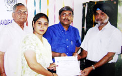 Additional deputy commissioner Upjeet Singh Brar giving away certificate to one of the twenty-five women trainees who were imparted training in embroidery by the Malwa Foundation at Bathinda