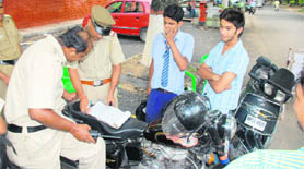 Cops verify the age and the documents of youngsters outside MCM DAV College.