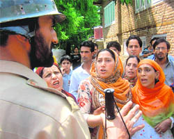 Policemen stop women protesters against Thursdays grenade attack in Srinagar on Friday.