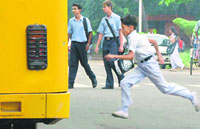 A schoolboy runs to catch the bus in Sector 16, Chandigarh.