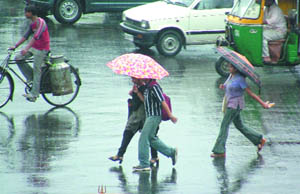 Girls with the umbrellas during rain in New Delhi on Saturday.