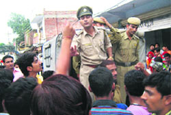 The police takes away students involved in the clash in Kangra