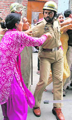 Kashmiri women scuffle with the police as the latter detains protesters in Srinagar on Saturday. People held a protest after the police detained Hilal War, chairman of the Peoples Political Party.