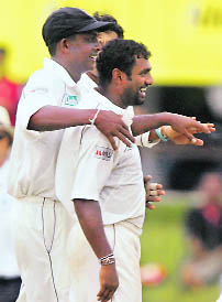 Sri Lankas Ajantha Mendis (L) and Muttiah Muralitharan celebrate their victory over India at their first Test match in Colombo on Saturday.