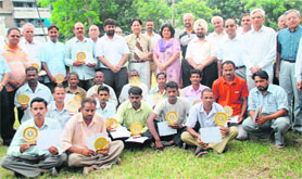 Employees of the horticulture wing of PU with their mementoes, commendation certificates and cash prizes during the culmination ceremony of the tree plantation drive on PU campus in Chandigarh on Sunday.