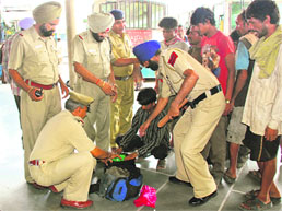 Cops check passengers luggage at ISBT-43 in Chandigarh on Sunday. 