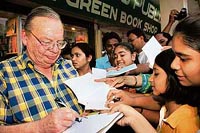 Ruskin Bond signs his The Book of Nature for children.