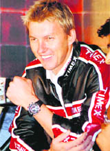 Australian cricketer and Timex brand ambassador Brett Lee poses with a newly launched watch, part of the "Conversation Starters Collection" in New Delhi on Monday.