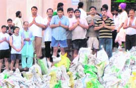 Members of the Aasra Welfare Society with the ashes of 500 unclaimed bodies cremated at various places in Haryana before immersing these in the Ganges in Hardwar.