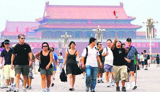 A group of foreign tourists walk on Tiananmen Square in Beijing on Monday. Avoid questions about income. Steer clear of religion and politics