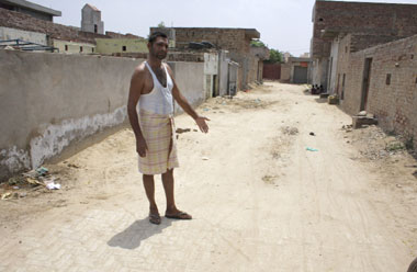 Standing in a lane of Narsingh colony in Doomwali within the boundary of Punjab, Gurpal Singh points towards the place from where territory of Haryana begins.