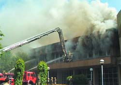 Delhi Fire Service personnel douse the fire that broke out at a conference complex of the Pragati Maidan exhibition centre in New Delhi on Tuesday.