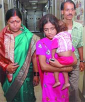Sunita Pande from Dhansa Road, Najafgarh, who has alleged harassment and murder threats by her mother-in-law, arrives with her parents at the office of the National Commission for Women in D.D.U.Marg, New Delhi, on Tuesday. 