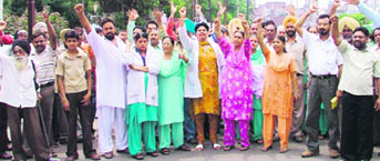 Health employees protest in Ludhiana on Tuesday.