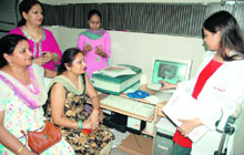 A doctor examines women at a free cancer check-up camp organised in Ludhiana on Tuesday.