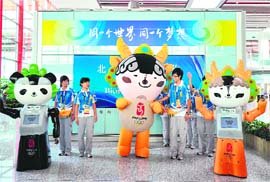 Olympics volunteers and robot mascots on hand to greet arriving visitors at Beijing airport's Terminal 3 on Tuesday