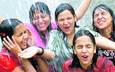 Young college girls enjoy the showers which brought down the temperature in Chandigarh on Wednesday.