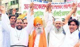 Members of different communities stage a protest against terrorism at Committee Chowk in Karnal